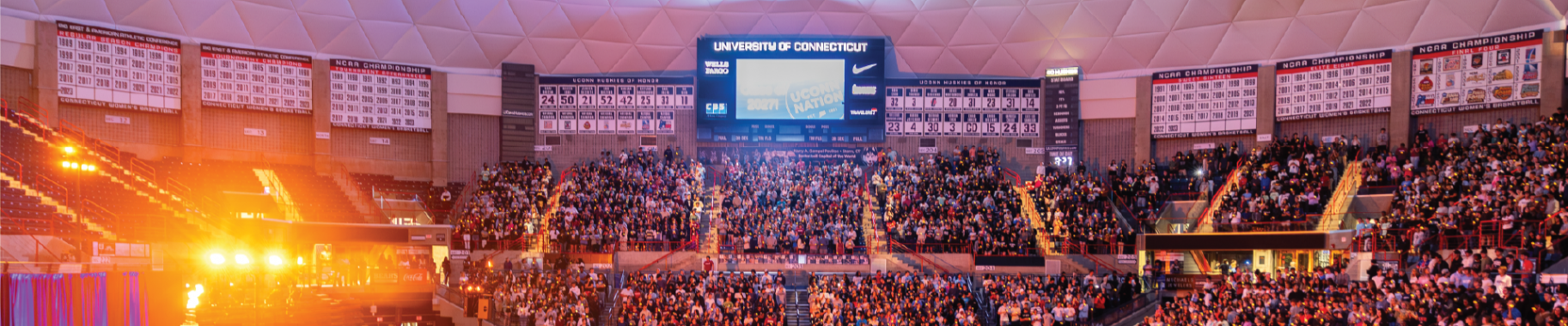 Convocation Fall 2024. Gampel pavilion filled with incoming freshman class of 2028. University of Connecticut digital board lit up.