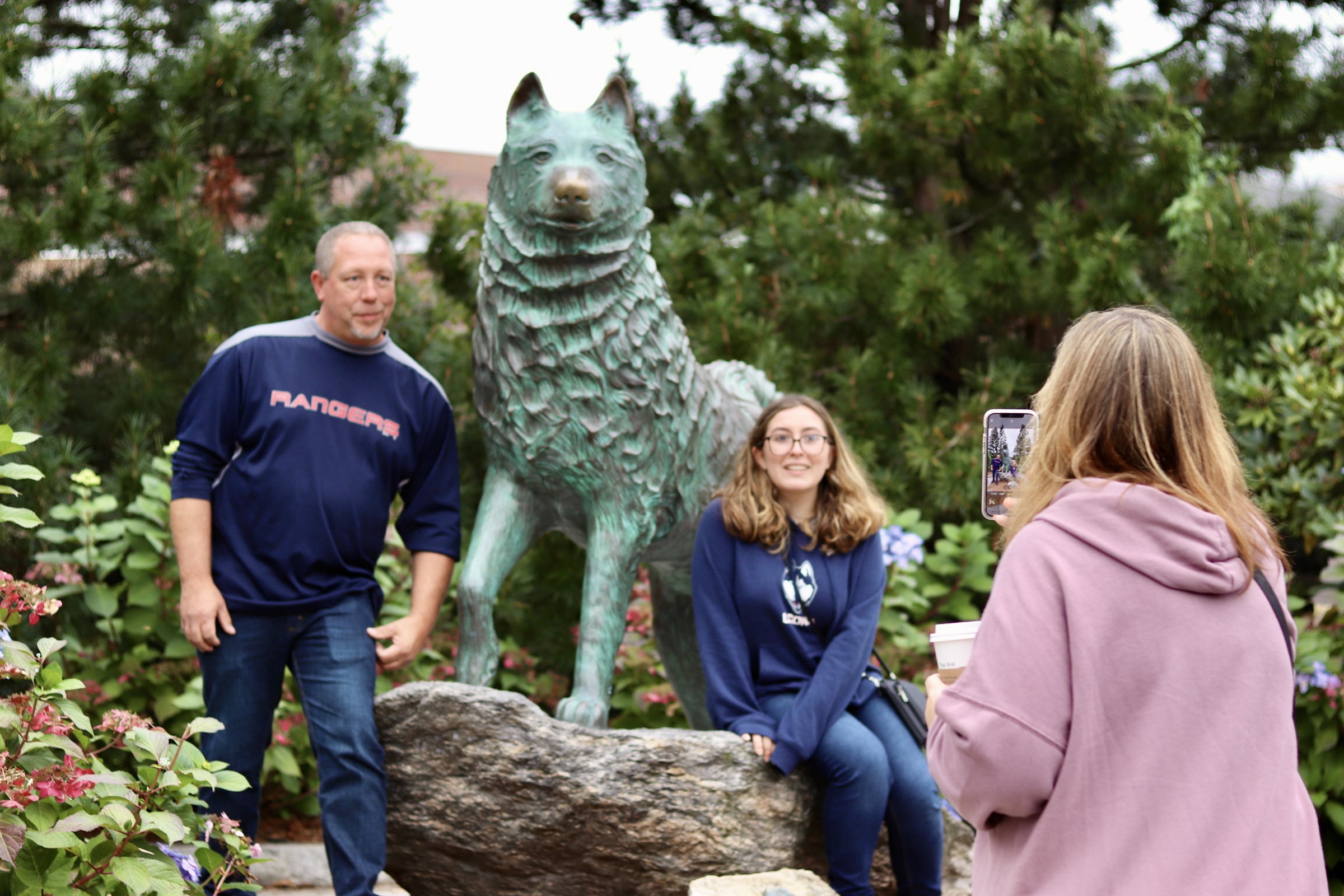 Family posing with Jonathan statue